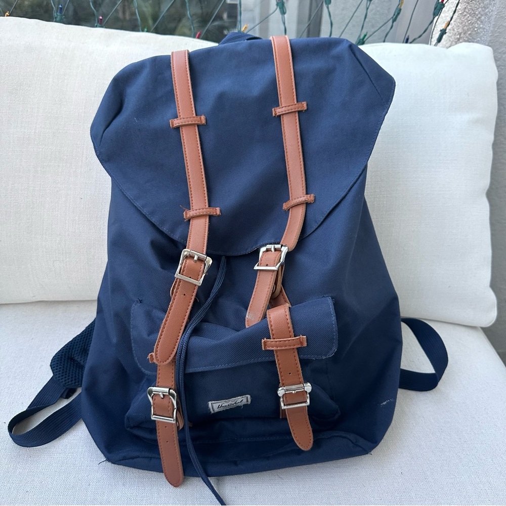 Herschel navy drawstring backpack with brown straps — clean, ready to use